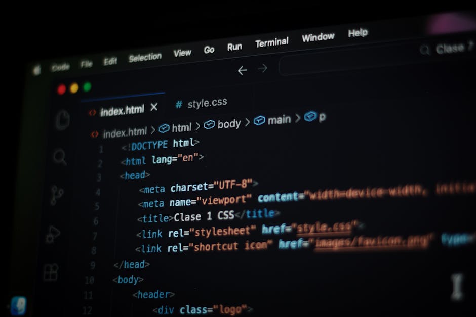 A close-up photograph of a computer screen displaying HTML code with color-coded tags for styling, including labels for 'red,' 'blue,' and 'green.' The code is slightly blurred, with the focus on the